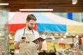 Supermarket Worker Calling Supplier Royalty Free Stock Photo