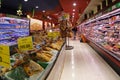 A supermarket worker replenishing stock in the fridges