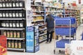 A supermarket worker restocking the shelves