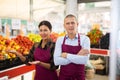 Supermarket workers in uniform standing in salesroom Royalty Free Stock Photo