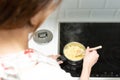 Supermom preparing dinner for a baby in a white modern kitchen