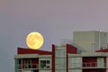 Supermoon climbed up to the roof of an apartment building