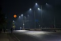 Supermoon image with empty street early in the morning