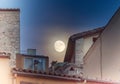 Supermoon over the rooftops of the old town of Girona, Catalonia