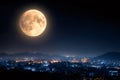 Supermoon rising over city lights at night Royalty Free Stock Photo