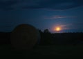 Supermoon sunrise on night sky with bundle of hay and trees. Czech republic landscape