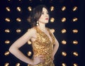 Superstar woman wearing golden shining dress posing