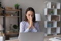 Superstitious young woman worker pray at workplace