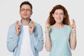 Superstitious young couple crossing fingers wishing for good luck concept Royalty Free Stock Photo