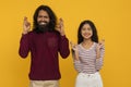 Superstitious young indian man and woman cross fingers Royalty Free Stock Photo