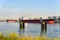 Supertanker ships being unloaded while moored to an oil dock