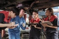 Supervisor engineer is teaching mechanic workers about car repair at a garage. Royalty Free Stock Photo