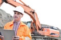 Supervisor looking away while holding clipboard at construction site Royalty Free Stock Photo