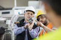 Supervisor and manual worker discussing over metal in industry Royalty Free Stock Photo