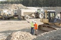 Supervisor showing something to colleague at construction site