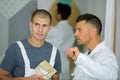 Supervisor talking to young male decorator on training course Royalty Free Stock Photo