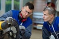 supervisor training apprentice to use circular saw Royalty Free Stock Photo