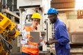 Supervisor, worker with hard hat working in manufacturing factory on business day Royalty Free Stock Photo