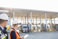 Supervisors looking at truck entering in shipping yard