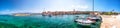 Seaside promenade and harbour in Supetar town on Brac island with palm trees and turquoise clear ocean water, Supetar, Brac, Croat