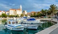 Supetar town on Brac Island, Croatia. Harbor with boats and palm trees