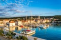 Supetar town on Brac Island, Croatia. Harbor with boats, palm trees, cafes and church Royalty Free Stock Photo