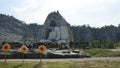 Big buddha carving on stone cliff of Wat Khao Tham Thiam in Suphanburi, Thailand