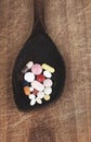 Suplements pills on wooden spoon Royalty Free Stock Photo