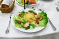 Supper at restaurant. Green salad with meat. Table setting