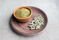 Supplement kratom green capsules and powder on brown plate. Herb Royalty Free Stock Photo