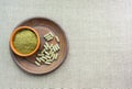 Supplement kratom green capsules and powder on brown plate. Herb Royalty Free Stock Photo
