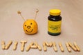 Supplements jar and a vitamin sign created from vitamin pills