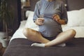 Pregnant woman taking prenatal vitamins during pregnancy, holding water glass and pill in her hands Royalty Free Stock Photo