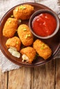 Suppli al telefono from Rome consists of deep-fried risotto rice with bolognese sauce and melting mozzarella closeup on the plate