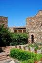 Supplier courtyard and gardens at the Nasrid Palace in Malaga castle. Royalty Free Stock Photo