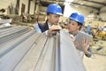 Supplier with engineer checking on production in metallurgic factory