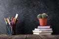 Supplies and cactus over notepads