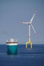 Supply boat with offshore wind turbine Royalty Free Stock Photo