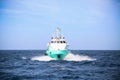 Supply boat transfer cargo to oil and gas industry and moving cargo from the boat to the platform, boat waiting transfer cargo Royalty Free Stock Photo
