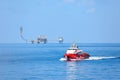 Supply boat transfer cargo to oil and gas industry and moving cargo from the boat to the platform, boat waiting transfer cargo Royalty Free Stock Photo