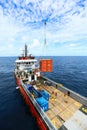 Supply boat transfer cargo to oil and gas industry and moving cargo from the boat to the platform, boat waiting transfer cargo Royalty Free Stock Photo