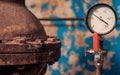 Supply pipe with red valve and pressure controller Royalty Free Stock Photo