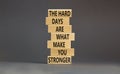 Support and be stronger symbol. Concept words The hard days are what make you stronger on wooden blocks. Beautiful grey table grey