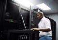 IT support, black man or coding on laptop in server room for big data, network glitch or digital website. Code, fixing Royalty Free Stock Photo