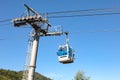 Support of the cable car and the closed cabin against the background of the sky and mountains