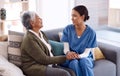 Support, caregiver holding hands with a senior woman and on sofa at nursing home for care. Consulting or healthcare Royalty Free Stock Photo
