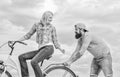 Support and friendship. Woman rides bicycle sky background. Service and assistance. Man helps keep balance ride bike Royalty Free Stock Photo
