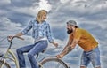 Support and friendship. Woman rides bicycle sky background. Service and assistance. Man helps keep balance ride bike Royalty Free Stock Photo