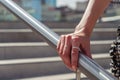 Support, help and people concept - close up of woman hand holding to railing Royalty Free Stock Photo