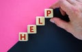 Support and help symbol. Wooden cubes with the word `help`. Businessman hand. Business, psychology, support and help concept. Royalty Free Stock Photo